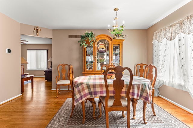 dining room featuring hardwood / wood-style floors and a chandelier