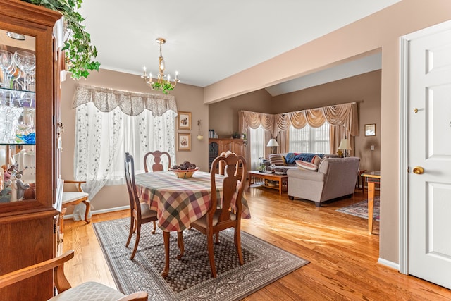 dining area with a notable chandelier and light wood-type flooring