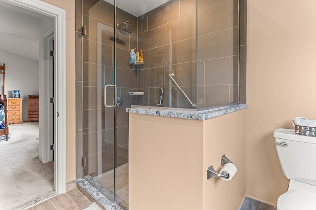 bathroom featuring an enclosed shower and toilet