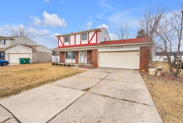 view of front facade with a garage, a front lawn, brick siding, and driveway