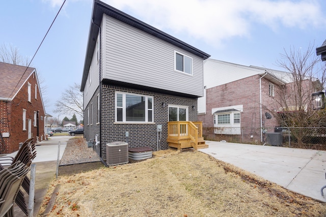 back of house with central AC unit