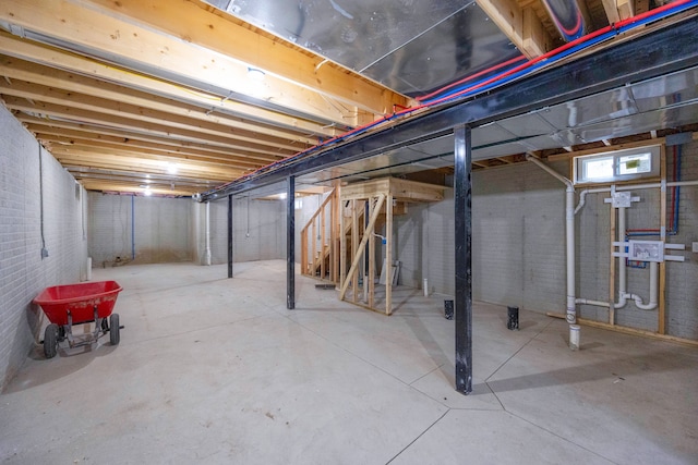 basement featuring brick wall