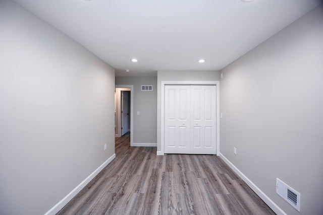 unfurnished bedroom with light hardwood / wood-style floors and a closet