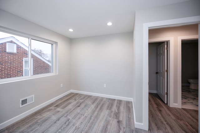 spare room with hardwood / wood-style floors