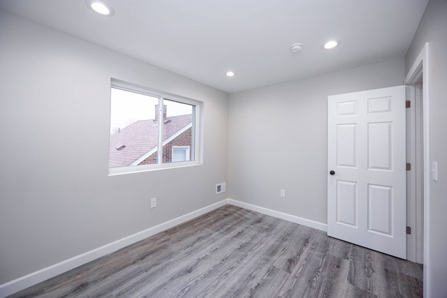 spare room with light hardwood / wood-style floors