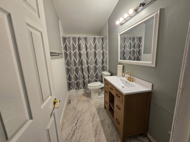 bathroom with vanity, toilet, and walk in shower