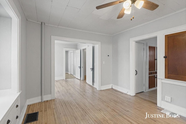 spare room featuring ornamental molding, light hardwood / wood-style floors, and ceiling fan