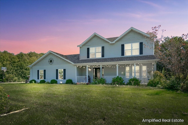 view of front of home with a porch and a lawn