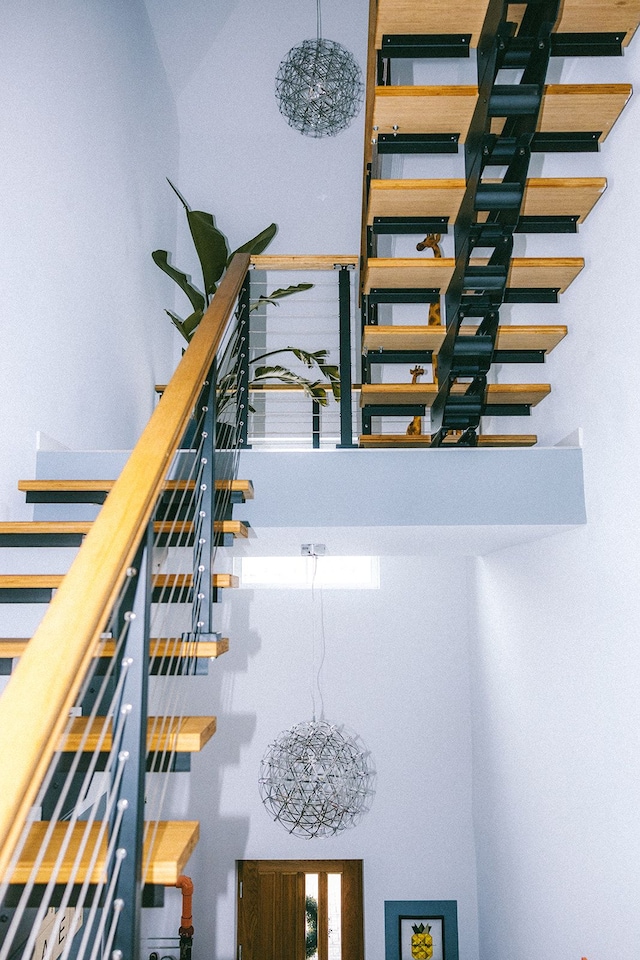 stairs featuring a towering ceiling