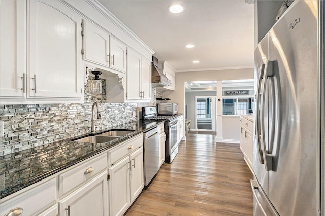 kitchen with stainless steel appliances, white cabinetry, and sink