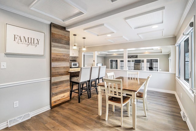 dining space featuring crown molding and wood-type flooring