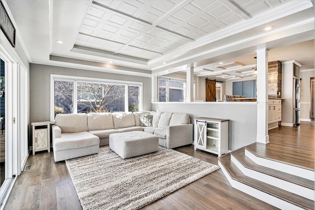 living room with dark hardwood / wood-style flooring, crown molding, and ornate columns