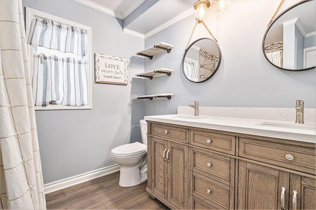 bathroom featuring vanity, hardwood / wood-style floors, crown molding, and toilet