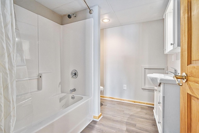 full bathroom featuring shower / tub combo with curtain, toilet, a paneled ceiling, vanity, and hardwood / wood-style flooring