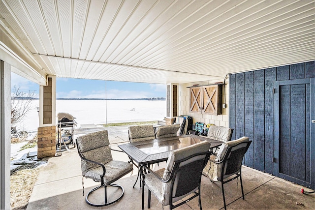 view of patio / terrace with a grill and a water view