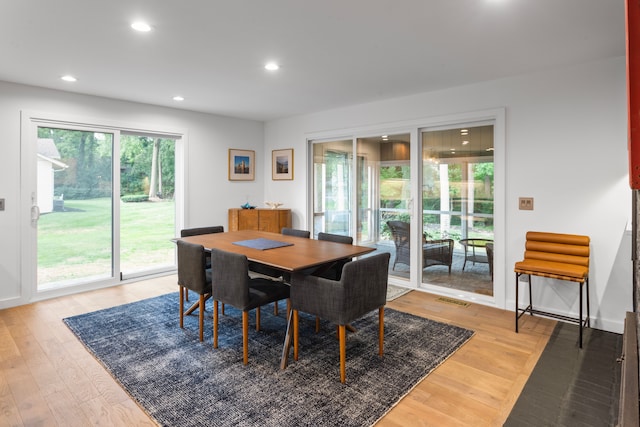 dining space with wood-type flooring