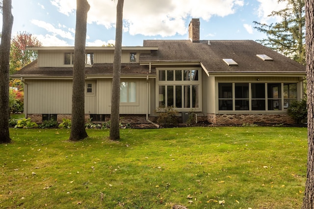 back of house featuring a lawn