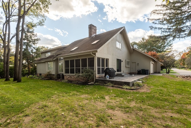 back of property featuring a lawn and a patio area