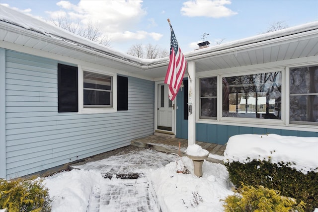 view of snow covered property entrance