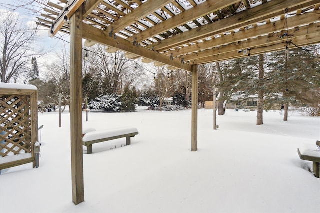 yard layered in snow with a pergola