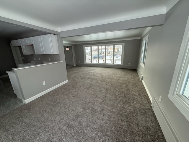 unfurnished living room featuring dark carpet and baseboard heating