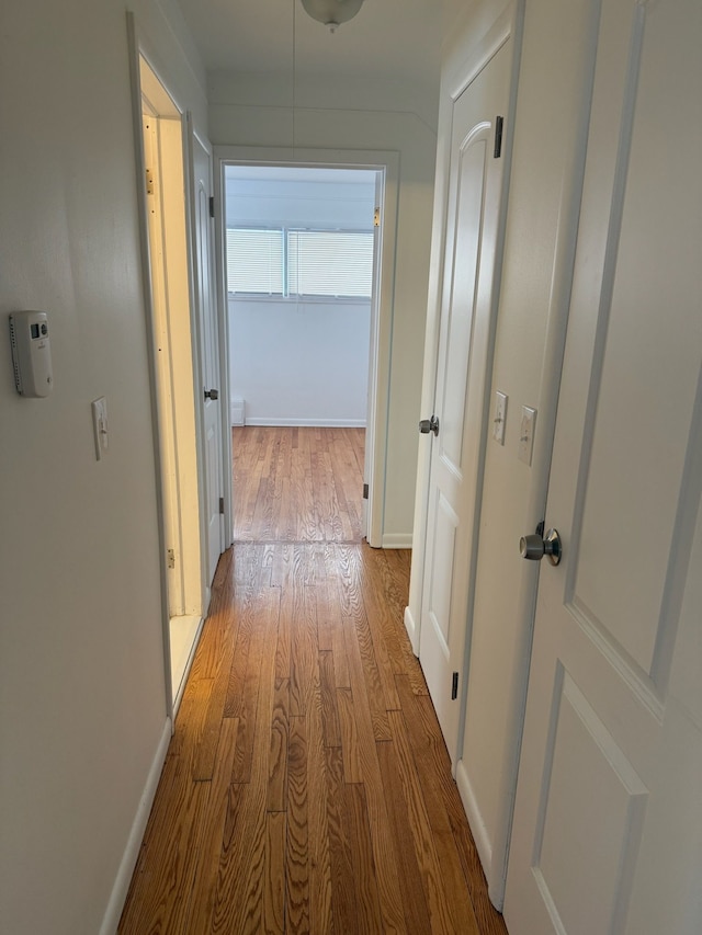 corridor with light wood-type flooring