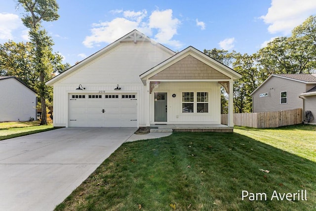 view of front facade with a garage, a front yard, and covered porch