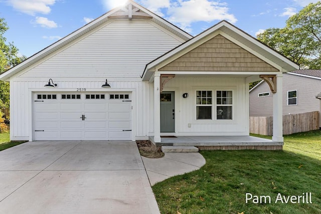 view of front facade with a garage, covered porch, and a front lawn