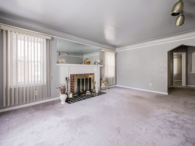 unfurnished living room featuring a fireplace and carpet