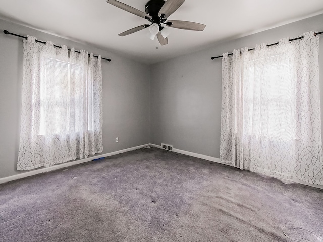 spare room featuring carpet floors and ceiling fan