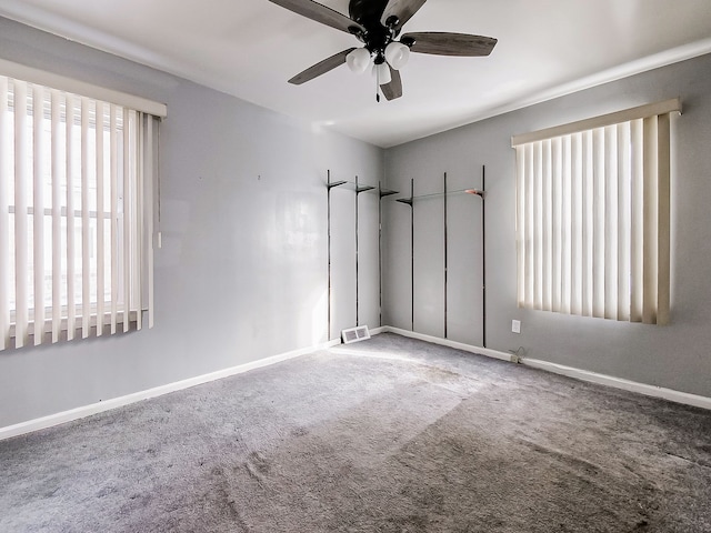 empty room featuring carpet floors and ceiling fan