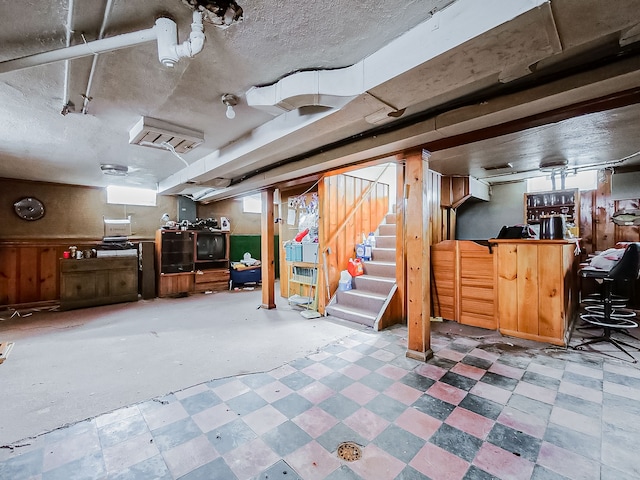 basement featuring plenty of natural light, bar area, and a textured ceiling