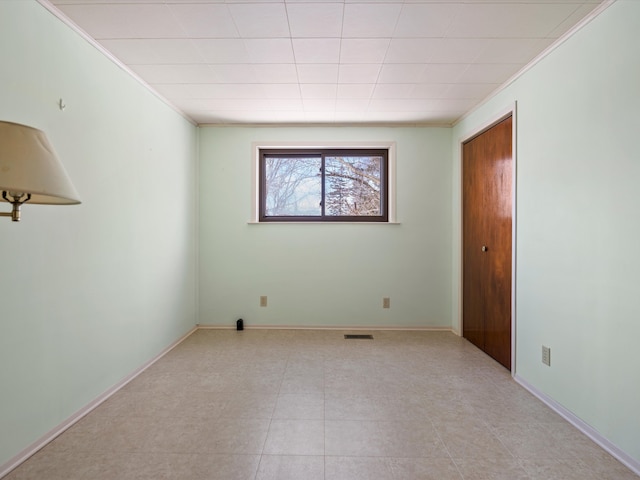 1397 N Channel Dr, Harsens Island, MI 48028 - unfurnished bedroom featuring crown molding, baseboards, and a closet