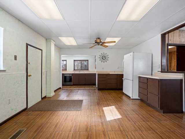 1397 N Channel Dr, Harsens Island, MI 48028 - kitchen featuring freestanding refrigerator, a paneled ceiling, light countertops, a sink, and ceiling fan
