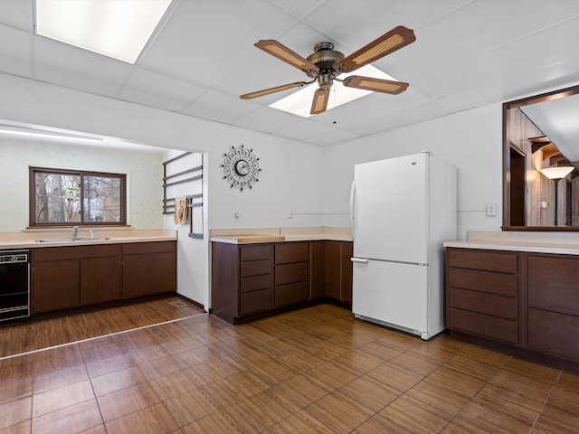 1397 N Channel Dr, Harsens Island, MI 48028 - kitchen with freestanding refrigerator, light countertops, a sink, and ceiling fan