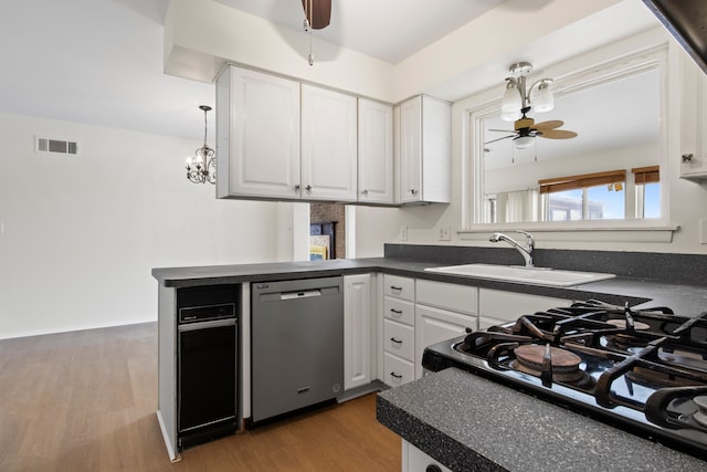 kitchen featuring ceiling fan, stainless steel dishwasher, gas stove, and white cabinets