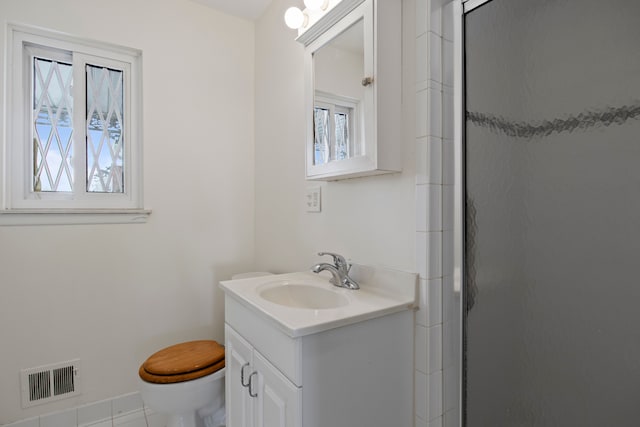 bathroom with vanity, walk in shower, and toilet