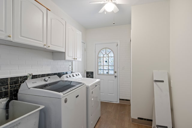 clothes washing area featuring sink, cabinets, separate washer and dryer, hardwood / wood-style flooring, and ceiling fan