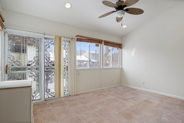 tiled spare room with ceiling fan