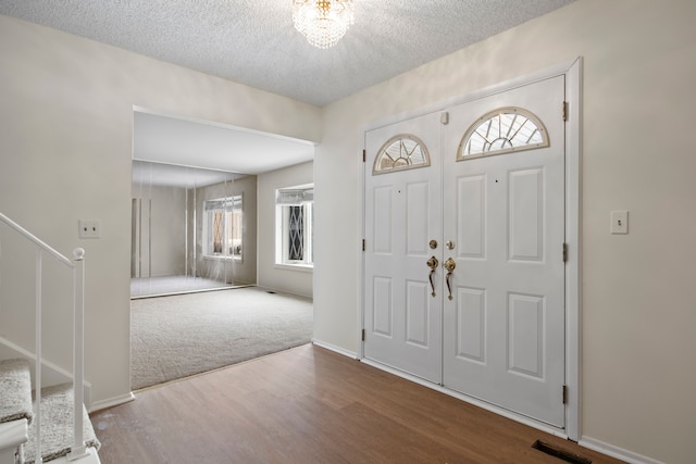 entrance foyer with hardwood / wood-style flooring and a textured ceiling