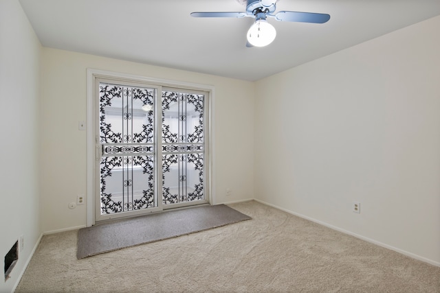 unfurnished room with ceiling fan and light colored carpet