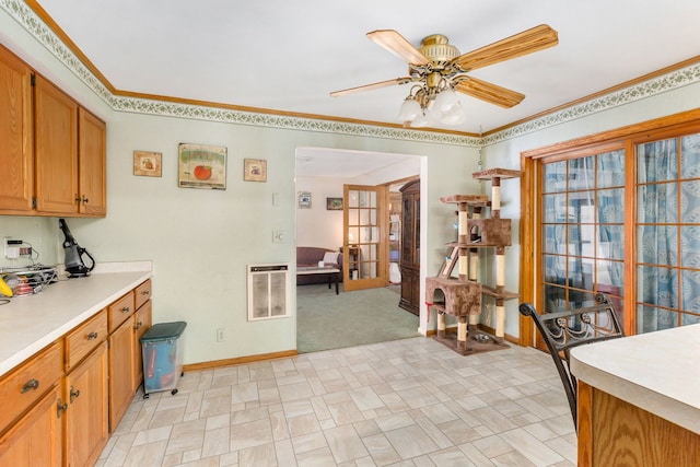 kitchen with ornamental molding, heating unit, ceiling fan, and french doors