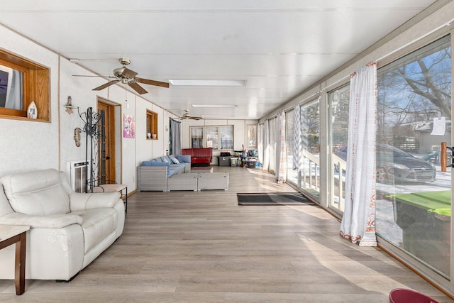 sunroom / solarium featuring ceiling fan