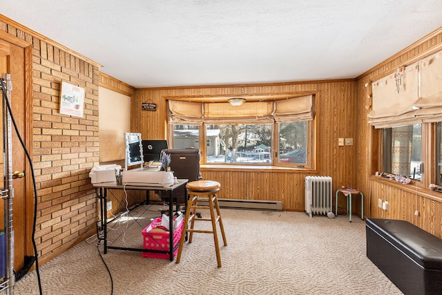 carpeted office space with baseboard heating, radiator, a textured ceiling, and wood walls