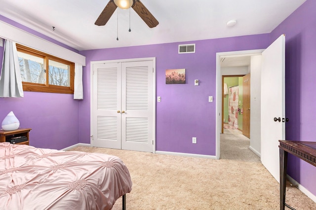 carpeted bedroom featuring ceiling fan and a closet