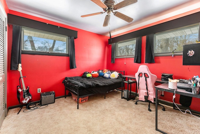 bedroom featuring multiple windows, light carpet, and ceiling fan