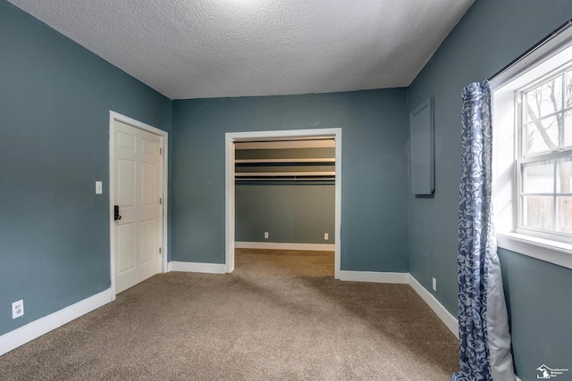 unfurnished bedroom featuring a textured ceiling and carpet flooring