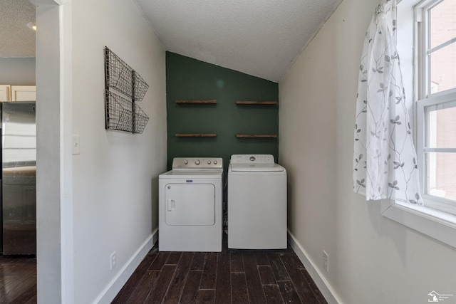 laundry room with dark hardwood / wood-style floors, a textured ceiling, washer and dryer, and a healthy amount of sunlight