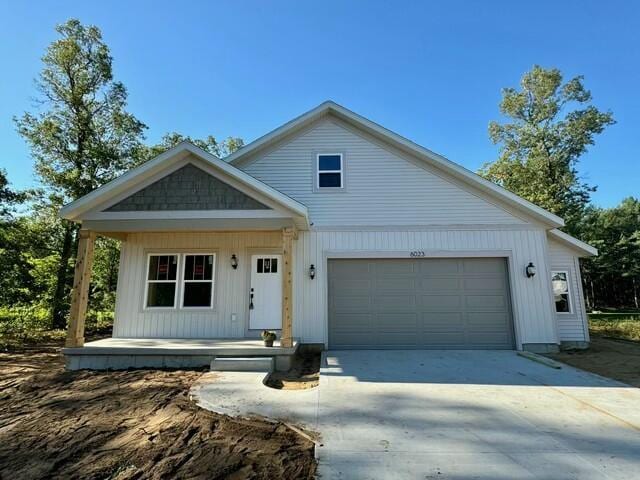 view of front of house featuring a garage and a porch