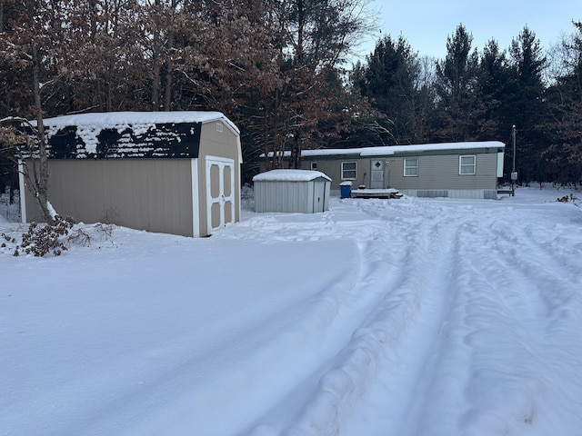 snowy yard with a storage unit